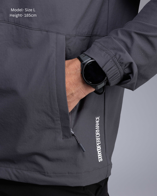 STRYD Performance Axis Tech Jacket – Men's premium gym jacket with athletic close-to-body fit and elastic-bound sleeves male model detail view Slate colour tech jacket Activewear Sunshine Coast