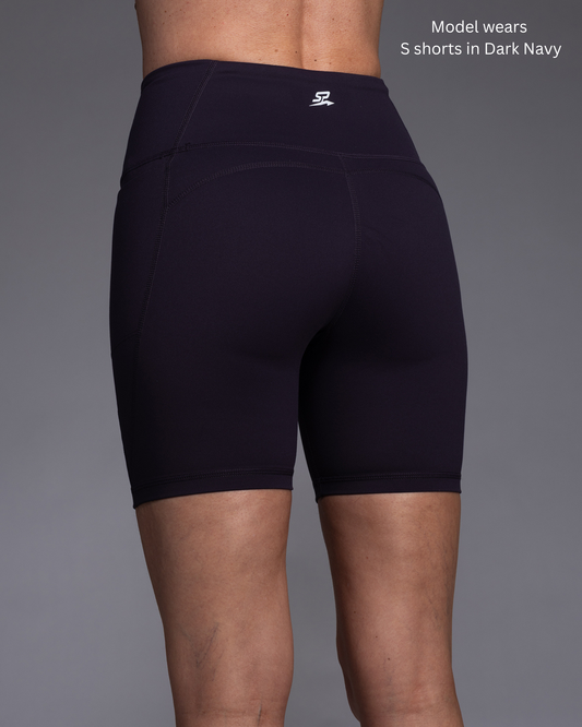 Womens Dark navy tight Training shorts worn by a model on a grey background PFAS Free Low Tox Lifestyle choice option in size small STRYD Performance Flex Form Tight Training Shorts rear view of shorts
