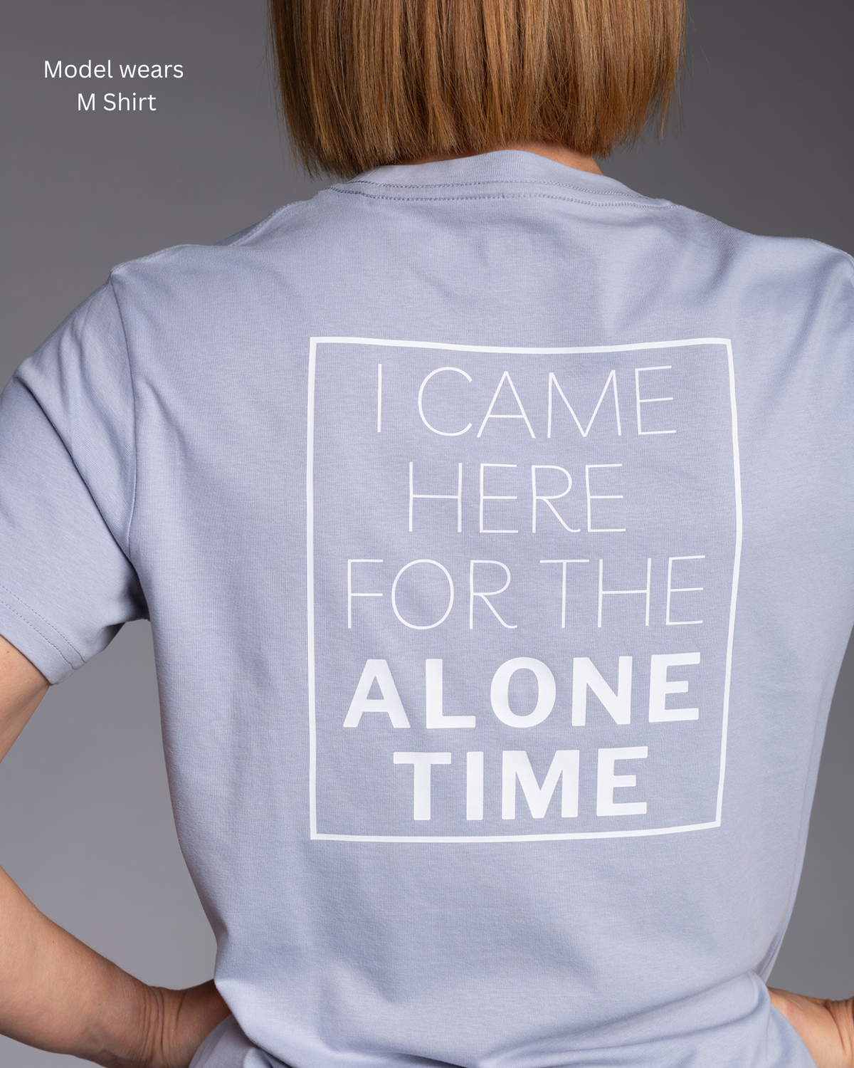STRYD Performance Muse Tee in Powder Blue, back view. I came here for the alone time print.