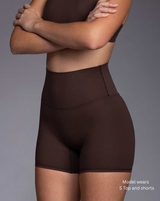 STRYD Performance Serenity tight training shorts in Rich Brown, front view with matching top.
