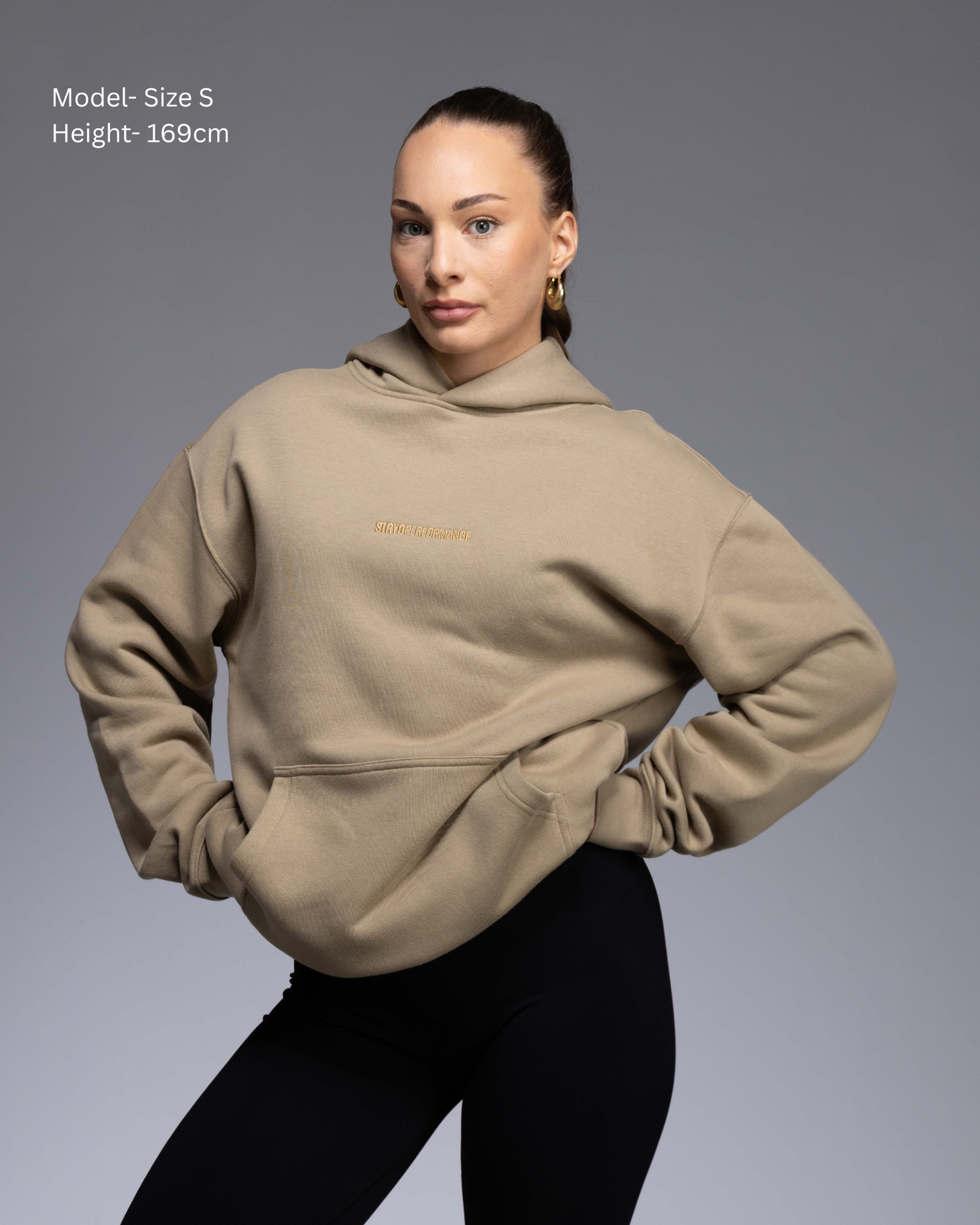 STRYD Performance Elite Unisex Hoodie in Bone — front view on female model, relaxed boxy silhouette, self-fabric lined hood | Premium gym wear Australia