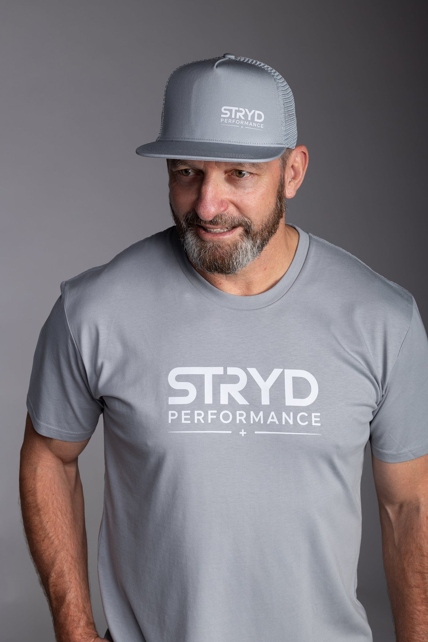 STRYD Performance Mesh Trucker snap back cap — front lifestyle view. Unisex premium gym cap Australia.