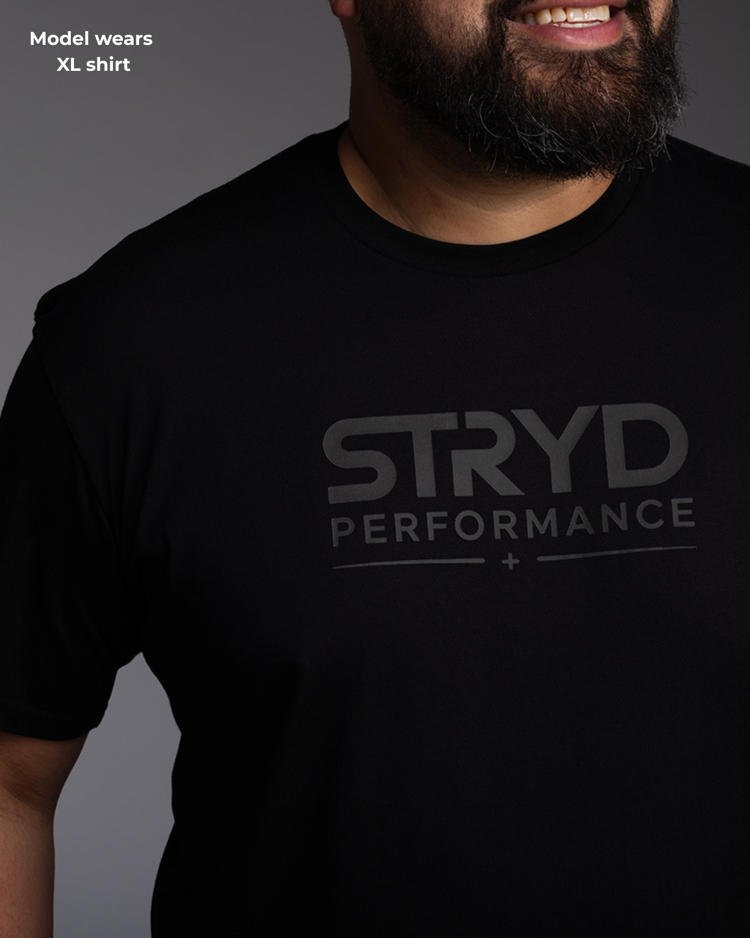 Male Model with beard in a black premium tshirt with classy black decals and logos of STRYD Performance