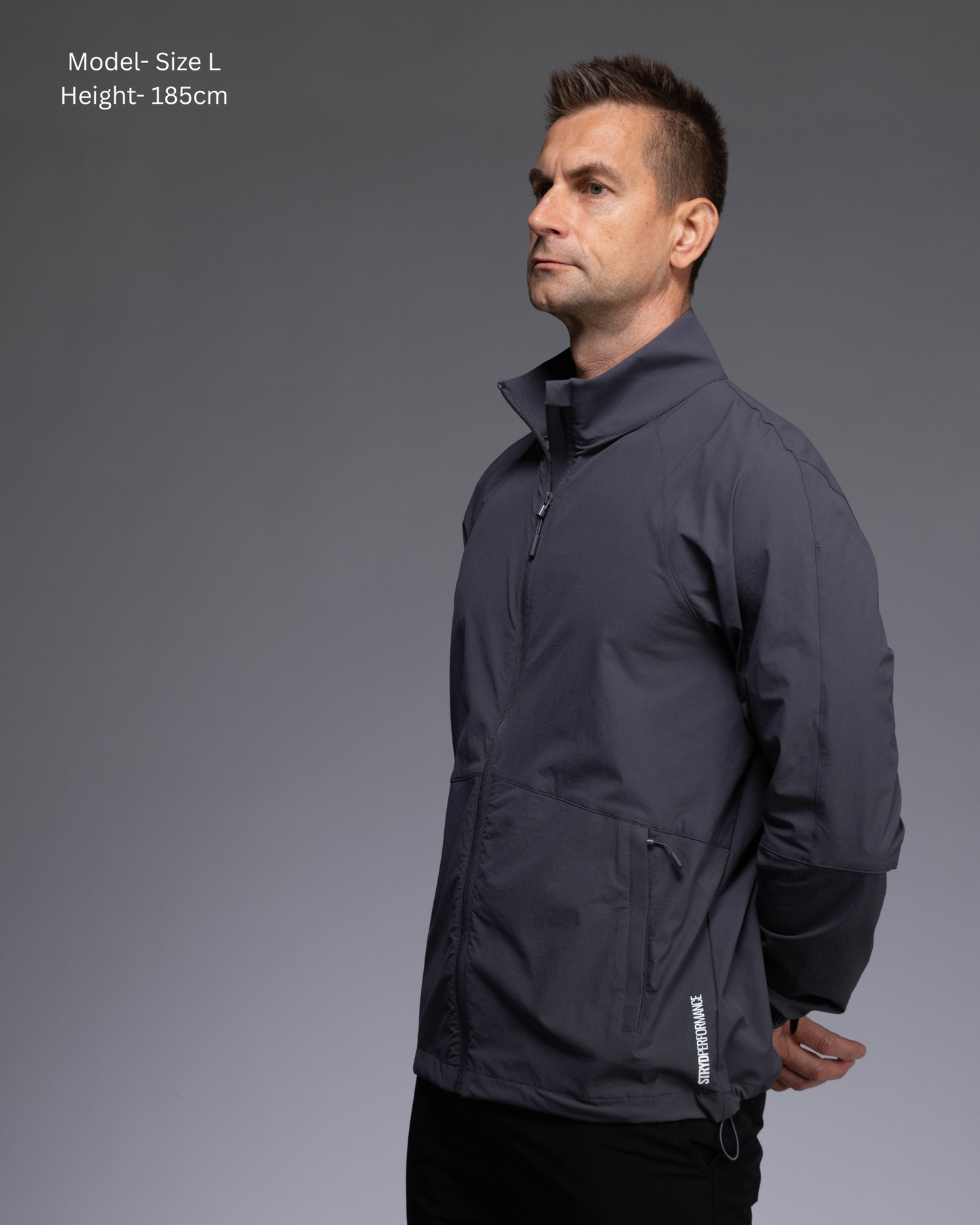 STRYD Performance Axis Tech Jacket – Men's premium gym jacket with athletic close-to-body fit and elastic-bound sleeves male model  front view Slate colour tech jacket Activewear Sunshine Coast