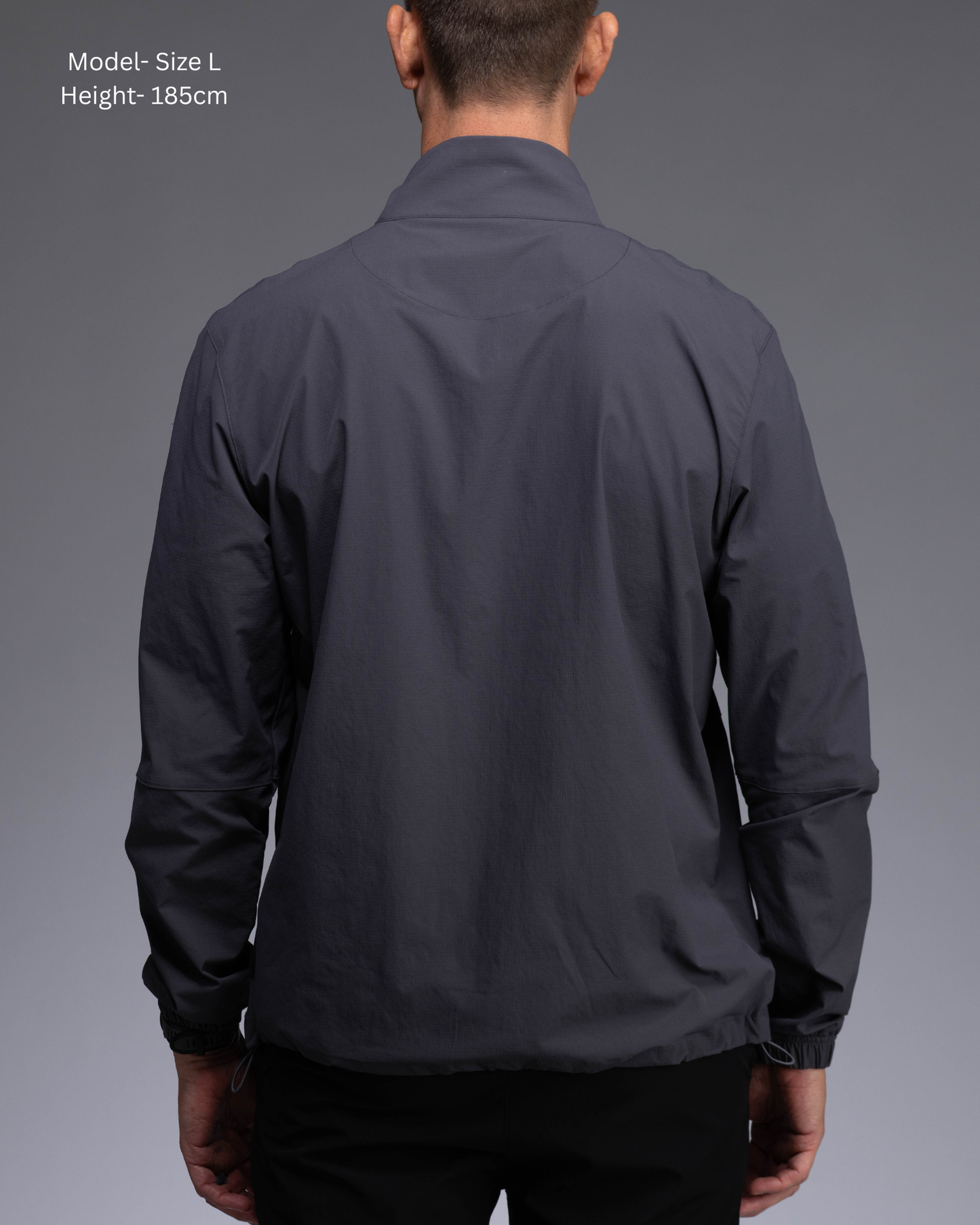 STRYD Performance Axis Tech Jacket – Men's premium gym jacket with athletic close-to-body fit and elastic-bound sleeves male model  back view Slate colour tech jacket Activewear Sunshine Coast