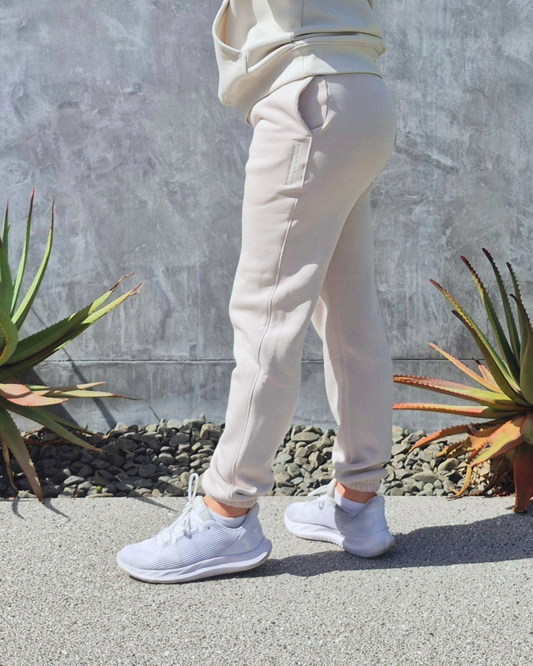 STRYD Performance Elite Womens Track Pant in Bone — side view styled with matching Elite Unisex Hoodie | Premium 320GSM fleece activewear Australia, Sunshine Coast 
activewear and gym wear Queensland, fast shipping within 24hrs of order and free shipping when you spend $140 AUD, Tracksuit pants, athleisure winter sets, premium apparel 