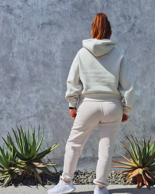 STRYD Performance Elite Womens Track Pant Bone — back view showing relaxed fit, back pocket and elasticated waistband | Premium gym wear Australia, paired with the Elite Hoodie,Sunshine Coast 
activewear and gym wear Queensland, fast shipping within 24hrs of order and free shipping when you spend $140 AUD, Tracksuit pants, athleisure winter sets, premium apparel

