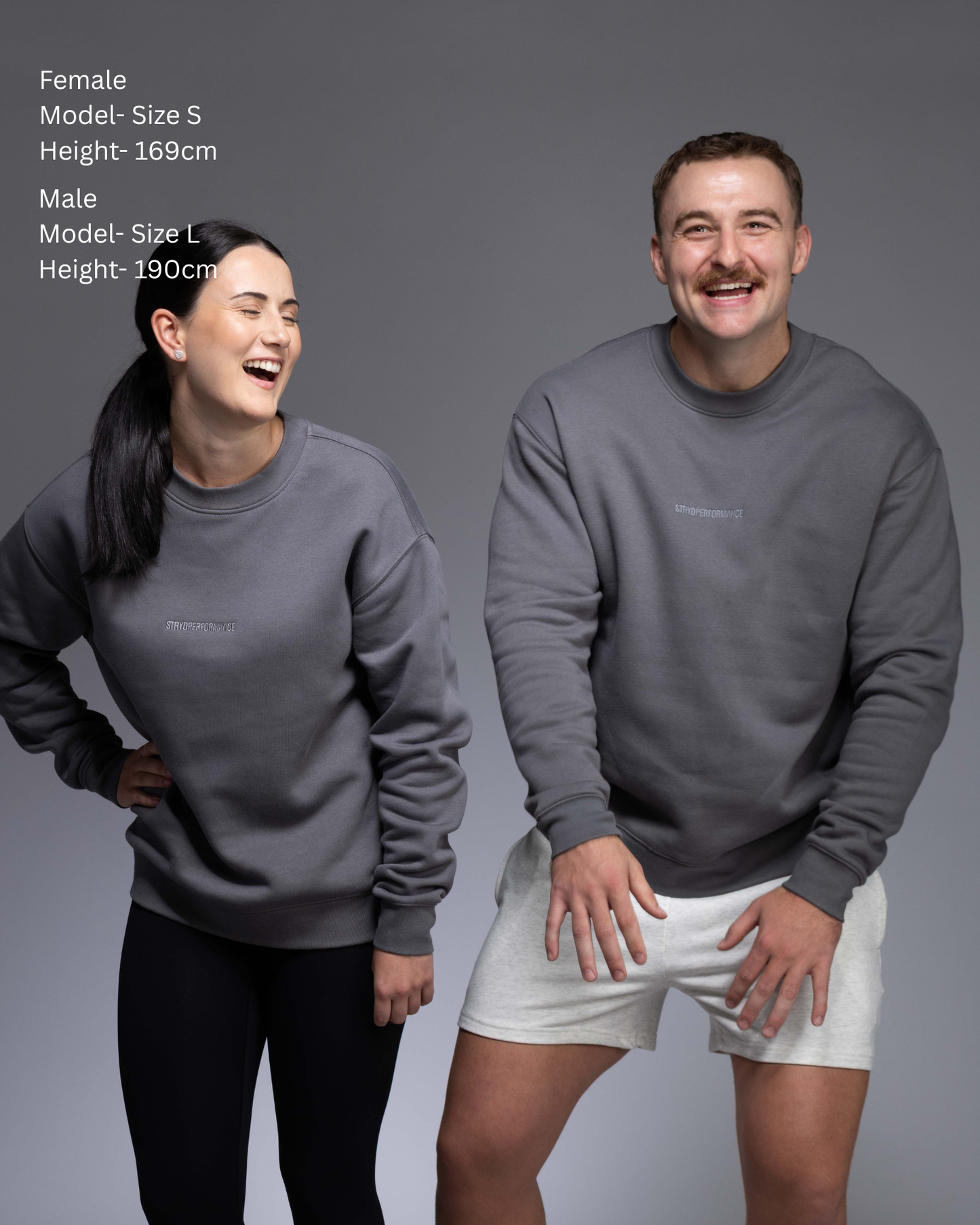 STRYD Performance Elite Unisex Crew in Slate — 320 GSM fleece, relaxed drop-shoulder fit, ribbed cuffs, premium activewear Australia, Sunshine Coast QLD Slate Colour Front view shop now free shipping over $150 male and female model side by side in matching elite Crew Sweaters