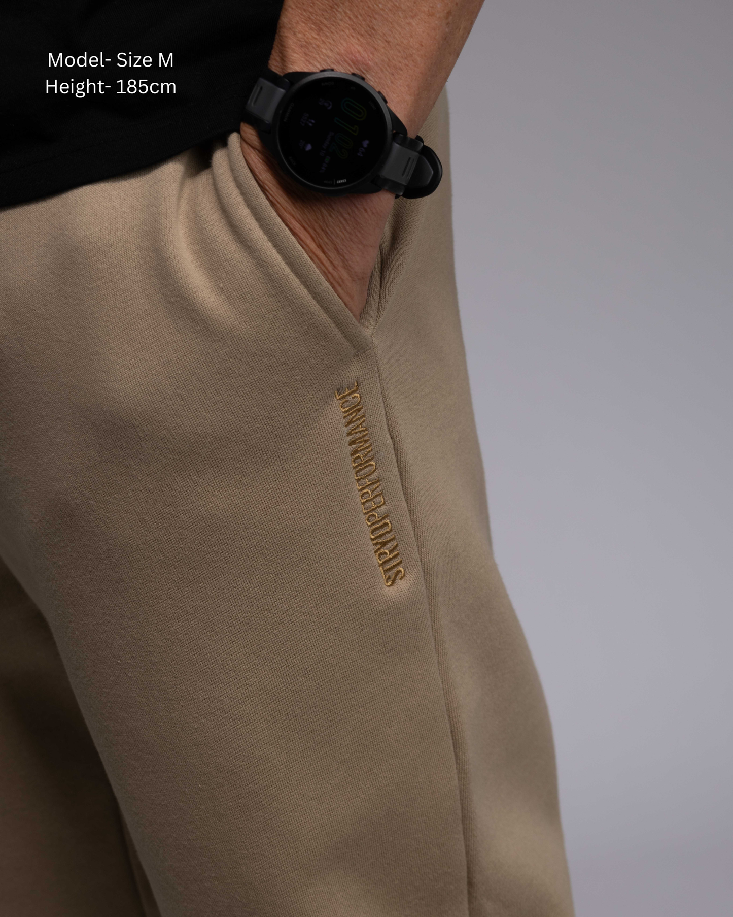 STRYD Performance Elite Unisex Track Pant in Sand —close in detail on male model, relaxed regular fit, elasticated waistband | Premium 320GSM fleece activewear Australia, Sunshine Coast 
activewear and gym wear Queensland, fast shipping within 24hrs of order and free shipping when you spend $150 AUD, Tracksuit pants, athleisure winter sets, premium apparel