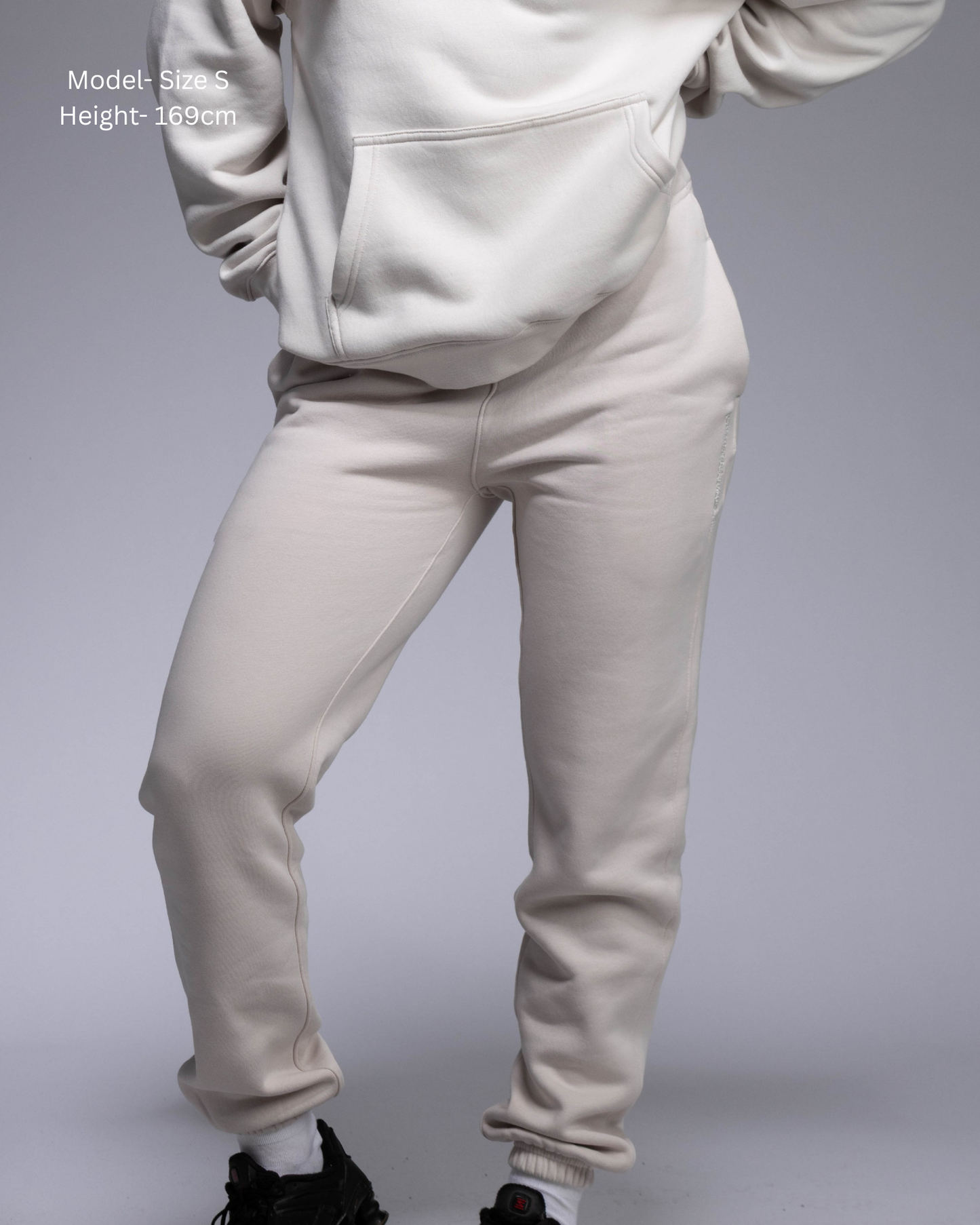 STRYD Performance Elite Womens Track Pant in Bone — front view styled with matching Elite Unisex Hoodie | Premium 320GSM fleece activewear Australia, Sunshine Coast 
activewear and gym wear Queensland, fast shipping within 24hrs of order and free shipping when you spend $150 AUD, Tracksuit pants, athleisure winter sets, premium apparel 