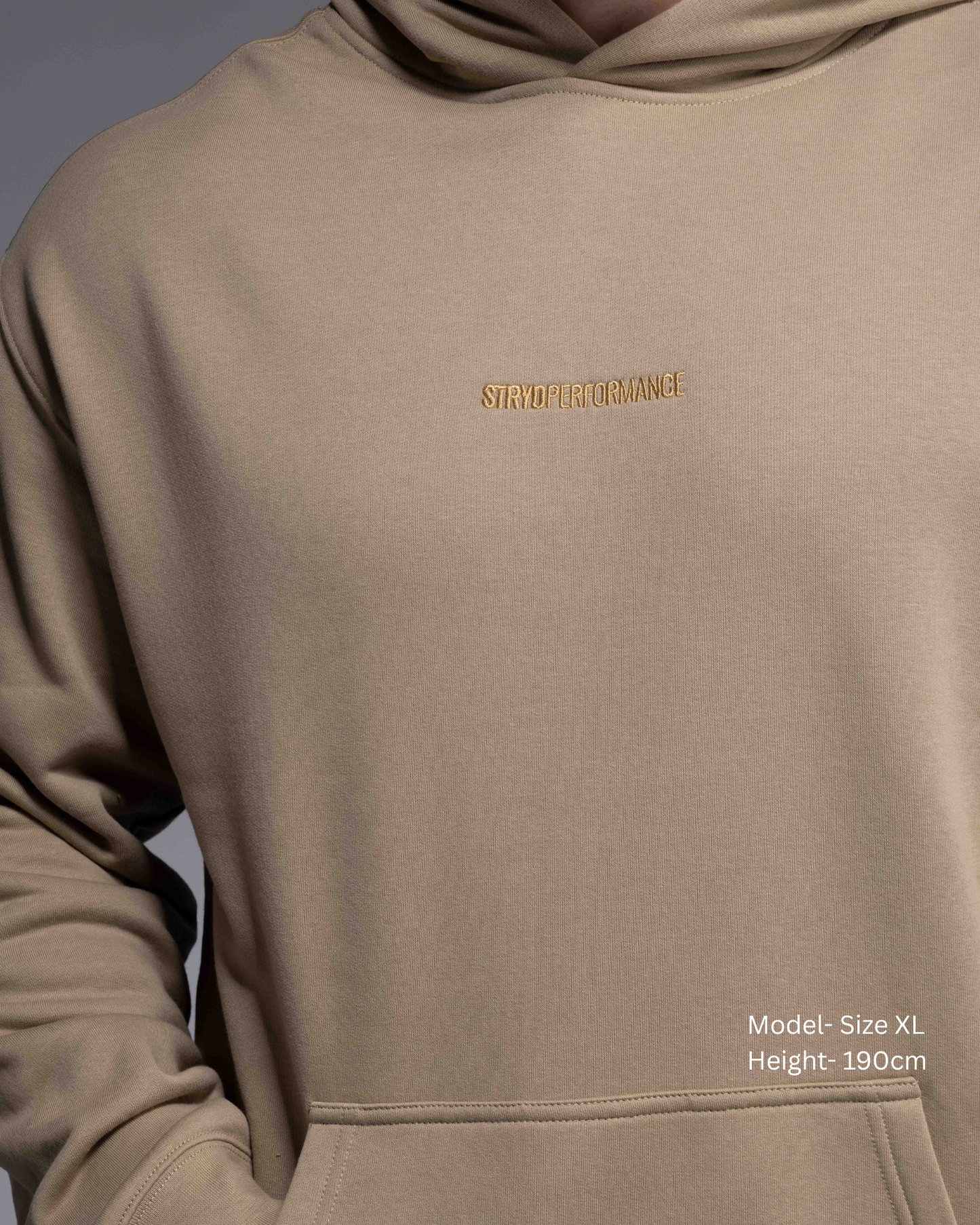 Premium Drop shoulder STRYD Performance Elite Unisex Hoodie in Sand — 320 GSM fleece, relaxed fit, drop-shoulder, ribbed cuffs, premium activewear Australia, Sunshine Coast activewear shop now free shipping over $150 Front detail View of Elite Hood male Model