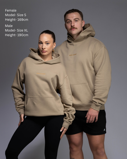 Premium Drop shoulder STRYD Performance Elite Unisex Hoodie in Sand — 320 GSM fleece, relaxed fit, drop-shoulder, ribbed cuffs, premium activewear Australia, Sunshine Coast activewear shop now free shipping over $150 Male and female models wearing sand coloured Elite Hoodies