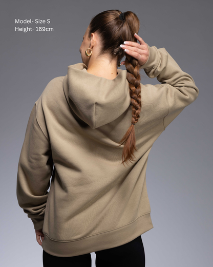 Premium Drop shoulder STRYD Performance Elite Unisex Hoodie in Sand — 320 GSM fleece, relaxed fit, drop-shoulder, ribbed cuffs, premium activewear Australia, Sunshine Coast activewear shop now free shipping over $150 back View of Elite Hood Female Model