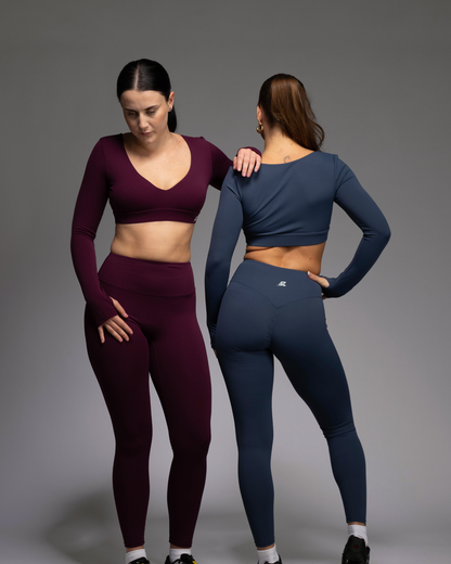 Haven Long Sleeve Crop Top in Berry and Teal front and back views of two female fitness models – women's sculpting compression training top | STRYD Performance

