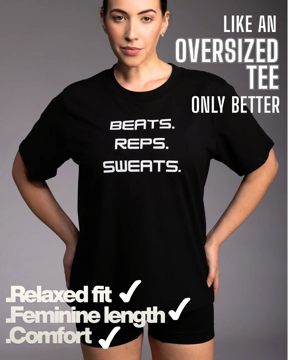 Person wearing a black t-shirt with text on a gray background