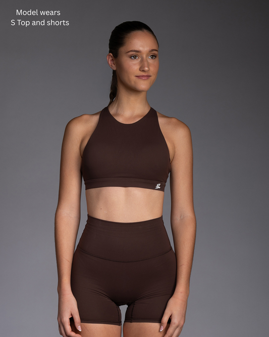 STRYD Performance Serenity cross back sports top in Rich Brown — lifestyle set view. Women's premium activewear Sunshine Coast QLD Australia.
