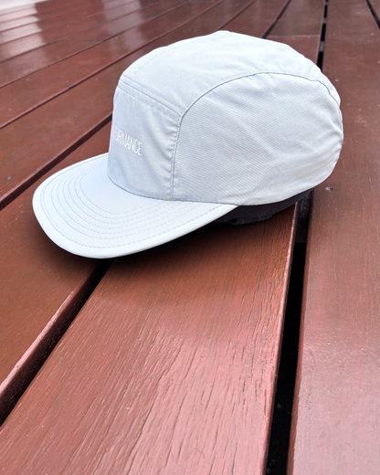 Light weight nylon sweat wicking running cap in stone grey colour with STRYD Performance logo on front, performance premium running cap Front left side view showing premium quality