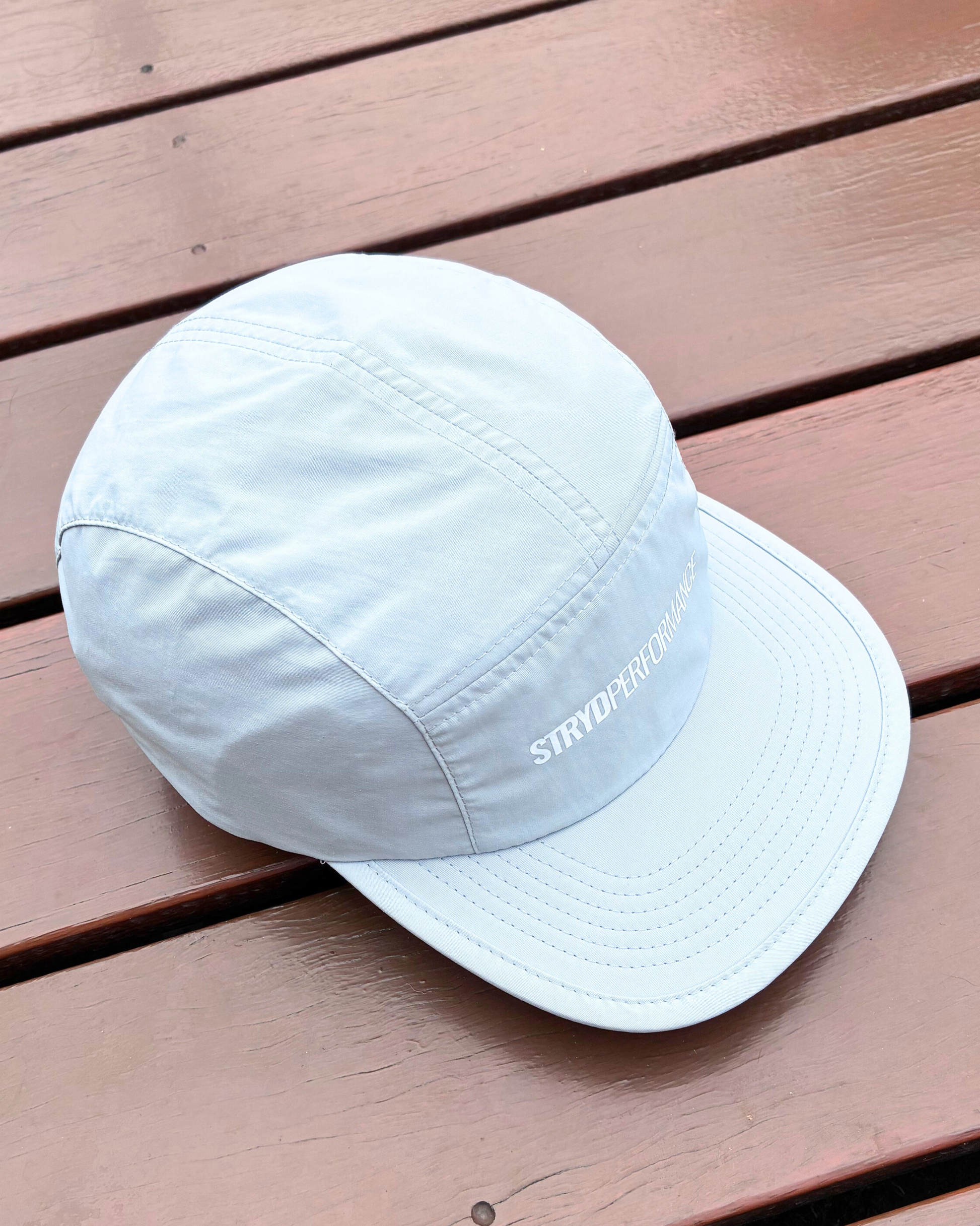 Light weight nylon sweat wicking running cap in stone grey colour with STRYD Performance logo on front, performance premium running cap Top view of cap