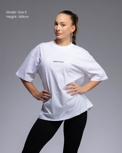 STRYD Performance I Like It Loose Block oversized unisex WHITE tee – front view relaxed fit gym and street style t-shirt female fitness model in Studio photo. shop sunshine coast performance activewear and gym fitness apparel