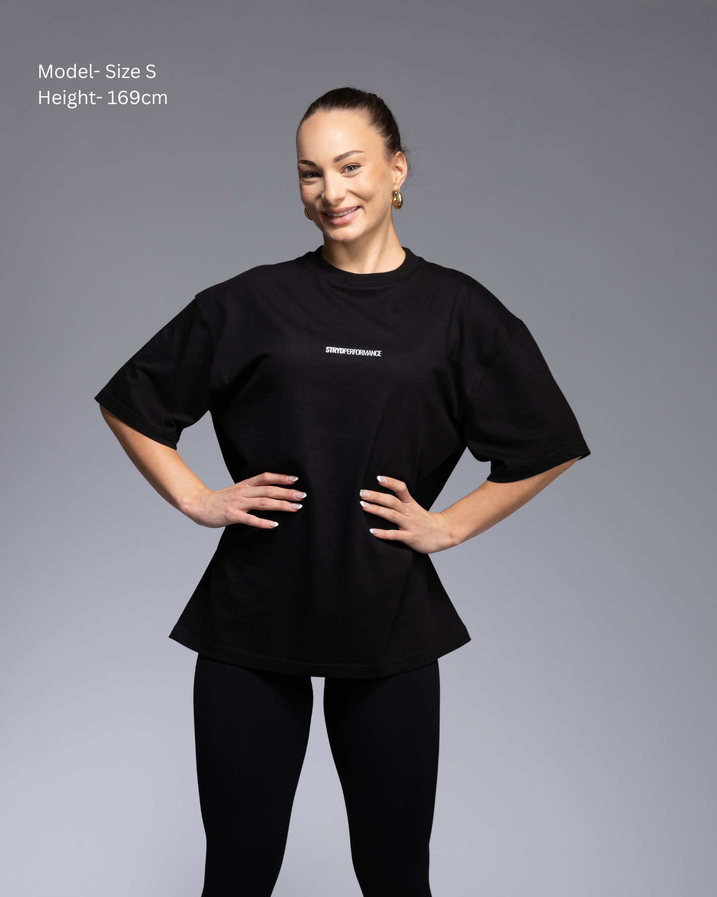 STRYD Performance I Like It Loose Block oversized unisex WHITE tee – Front view relaxed fit gym and street style t-shirt female fitness model in Studio photo. shop sunshine coast performance activewear and gym fitness apparel