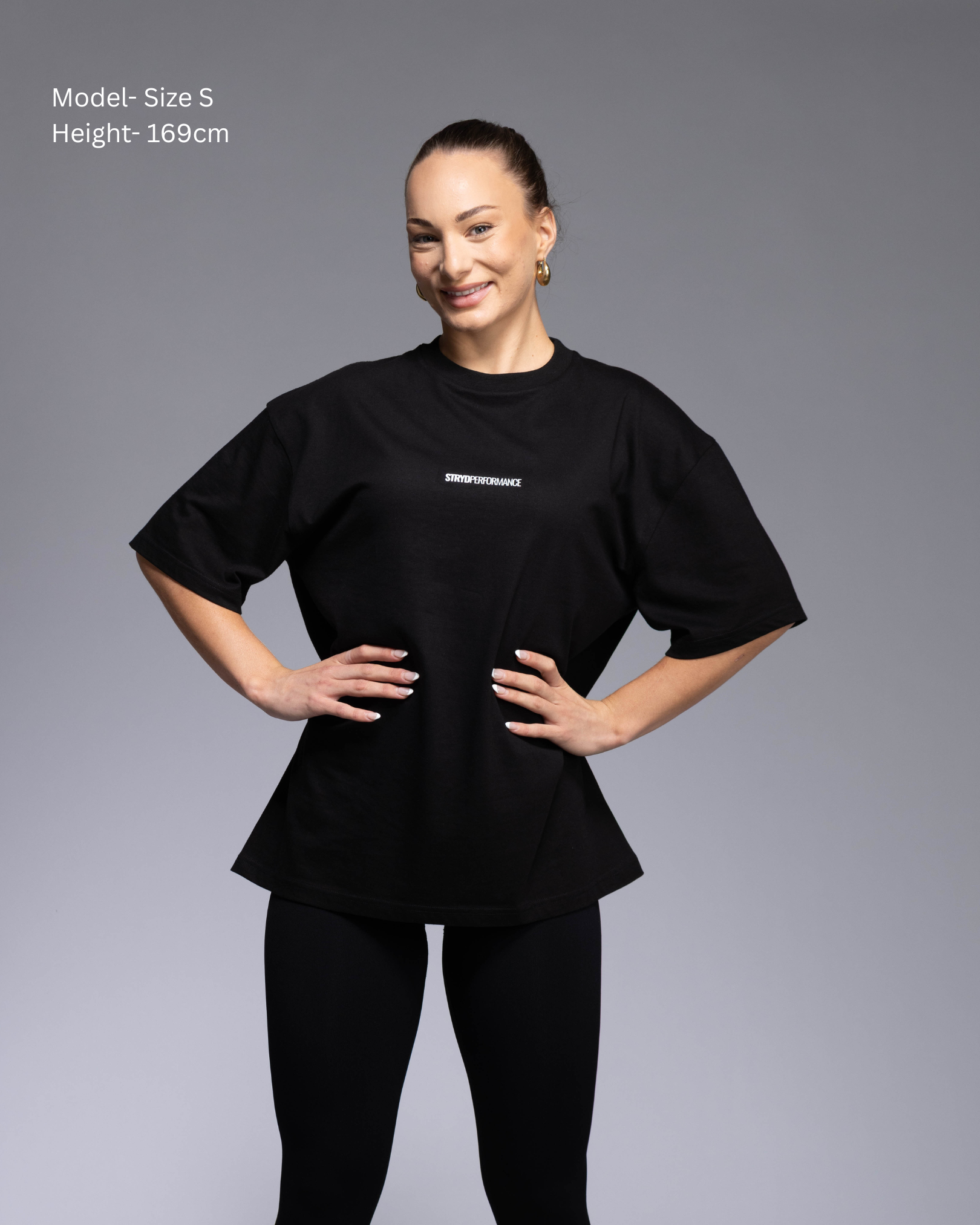 STRYD Performance I Like It Loose Block oversized unisex WHITE tee – Front view relaxed fit gym and street style t-shirt female fitness model in Studio photo. shop sunshine coast performance activewear and gym fitness apparel