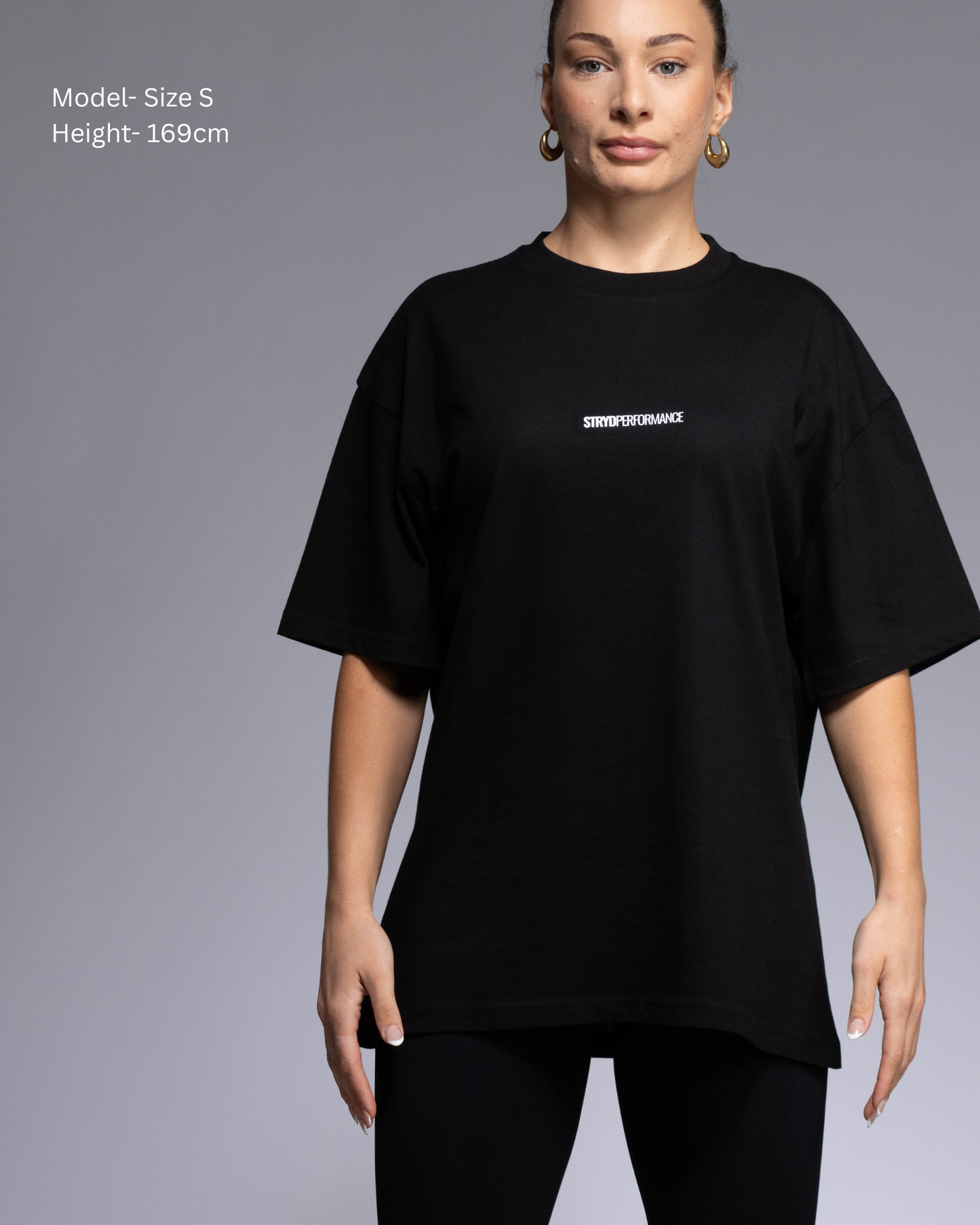STRYD Performance I Like It Loose Block oversized unisex WHITE tee – Front view relaxed fit gym and street style t-shirt female fitness model in Studio photo. shop sunshine coast performance activewear and gym fitness apparel
