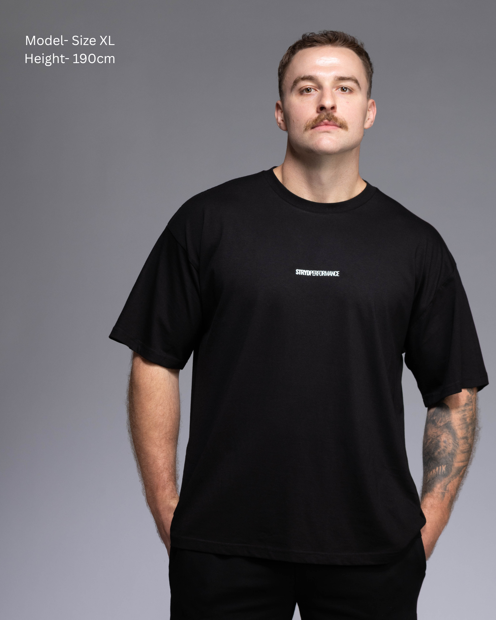 STRYD Performance I Like It Loose Block oversized unisex BLACK tee – Front view relaxed fit gym and street style t-shirt Male fitness model in Studio shot. shop sunshine coast performance activewear and gym fitness apparel