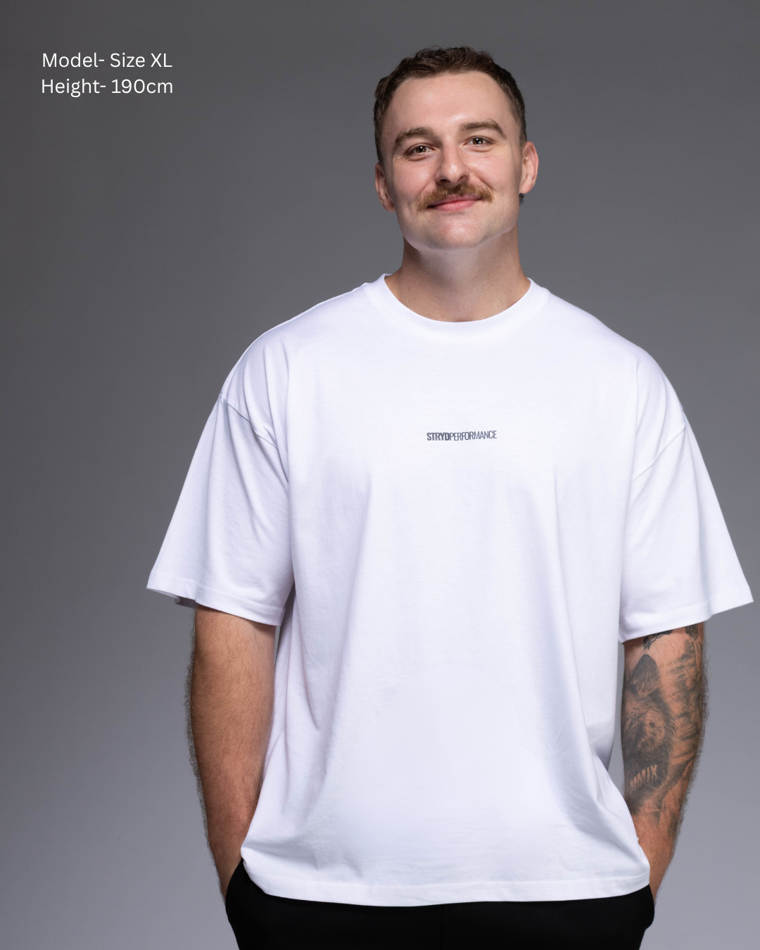STRYD Performance I Like It Loose Block oversized unisex WHITE tee – Front view relaxed fit gym and street style t-shirt Male fitness model in Studio shot. shop sunshine coast performance activewear and gym fitness apparel
