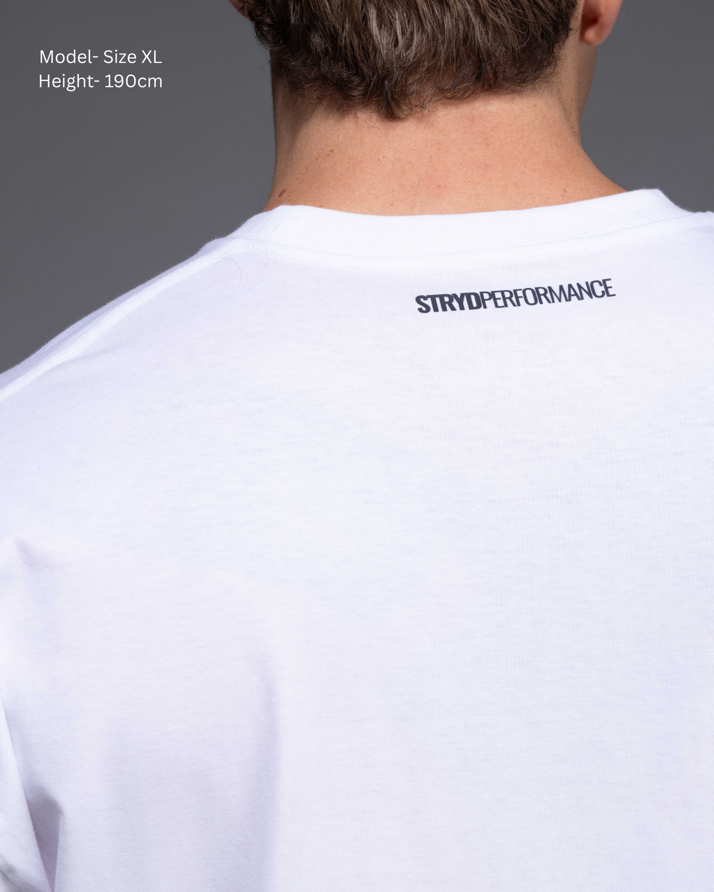 STRYD Performance I Like It Loose Block oversized unisex WHITE tee – back detail view relaxed fit gym and street style t-shirt male fitness model in Studio photo. shop sunshine coast performance activewear and gym fitness apparel