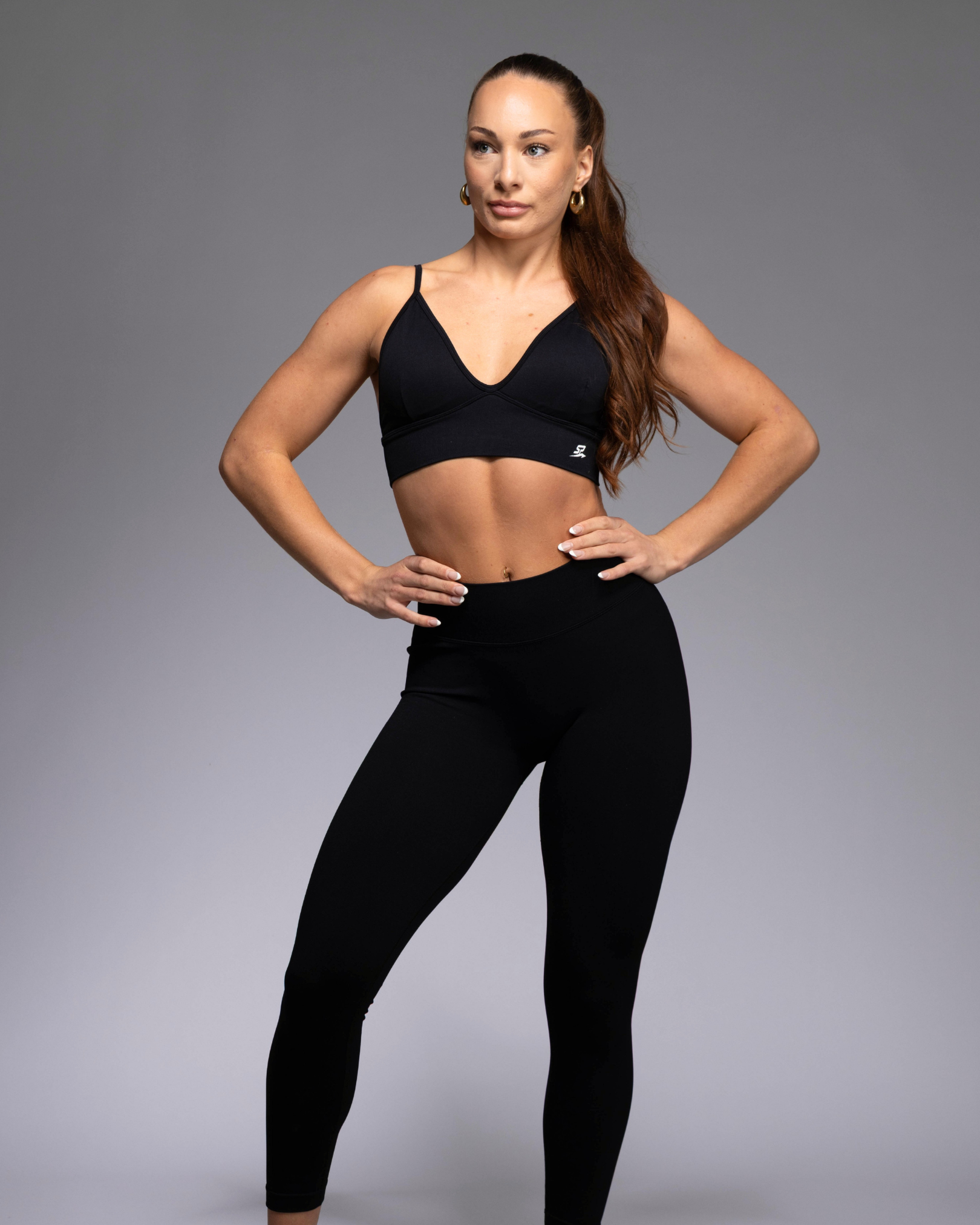STRYD Performance Peaches push up sports top in black— Front view. Women's premium push up activewear top.