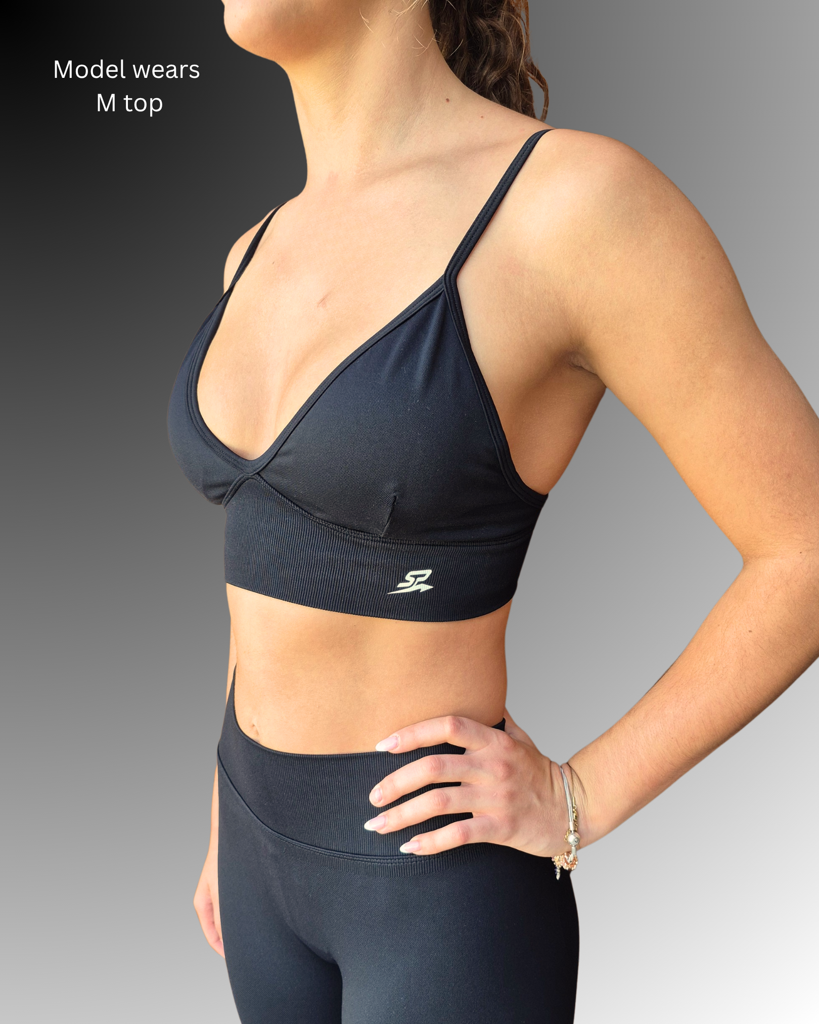 STRYD Performance Peaches push up sports top in black— side view. Women's premium push up activewear top.