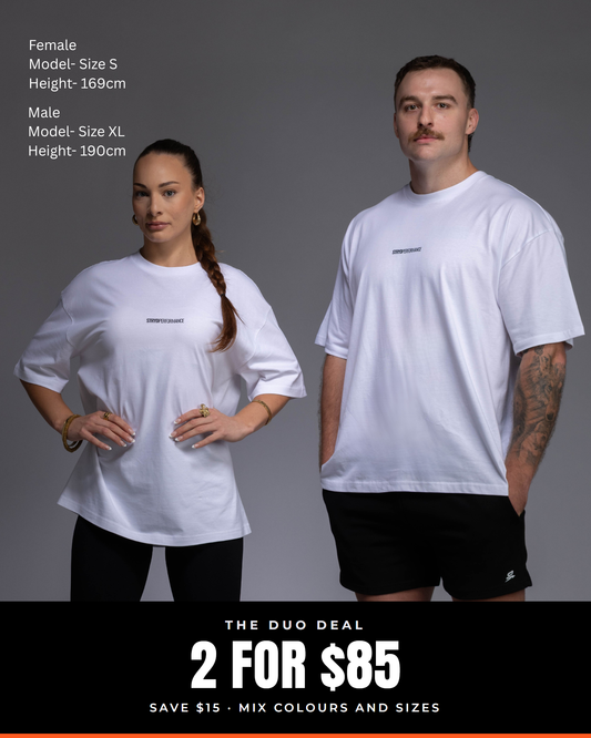 Man and woman in white I Like It Loose Block oversized tees. Text: The Duo Deal, 2 for $85, save $15, mix colours and sizes.