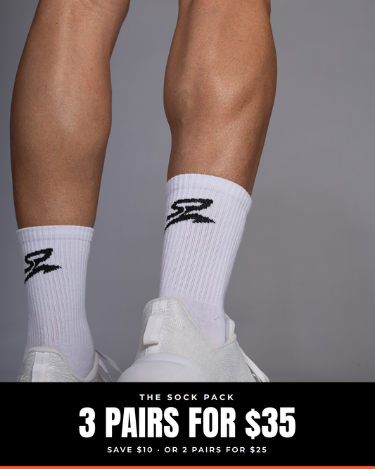 Performance Crew Socks in White, worn with white trainers. Text: The Sock Pack, 3 pairs for $35, save $10, or 2 pairs for $25.