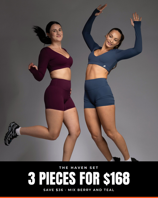 Two women jumping in HAVEN high-rise shorts and long-sleeve crops in Berry and Teal. Text: The HAVEN Set, 3 pieces for $168, save $36, mix Berry and Teal.