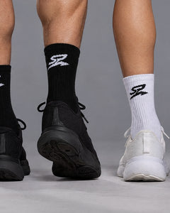 Performance Crew Socks in black and white, worn side by side