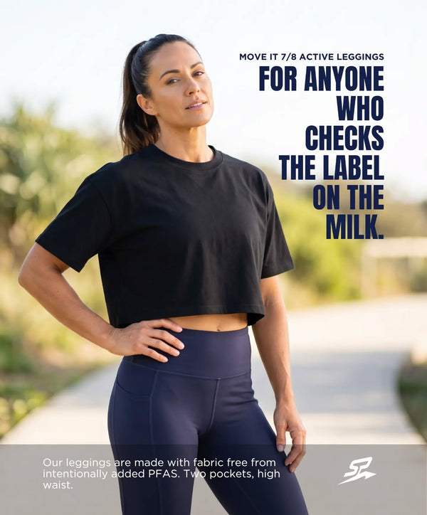 Woman wearing the CROP IT LIKE ITS HOT Black Stealth cropped tee and MOVE IT 7/8 leggings in navy